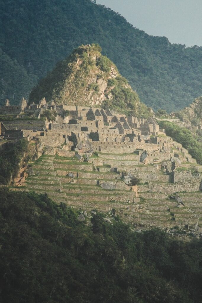 A large stone structure sitting on top of a lush green hillside